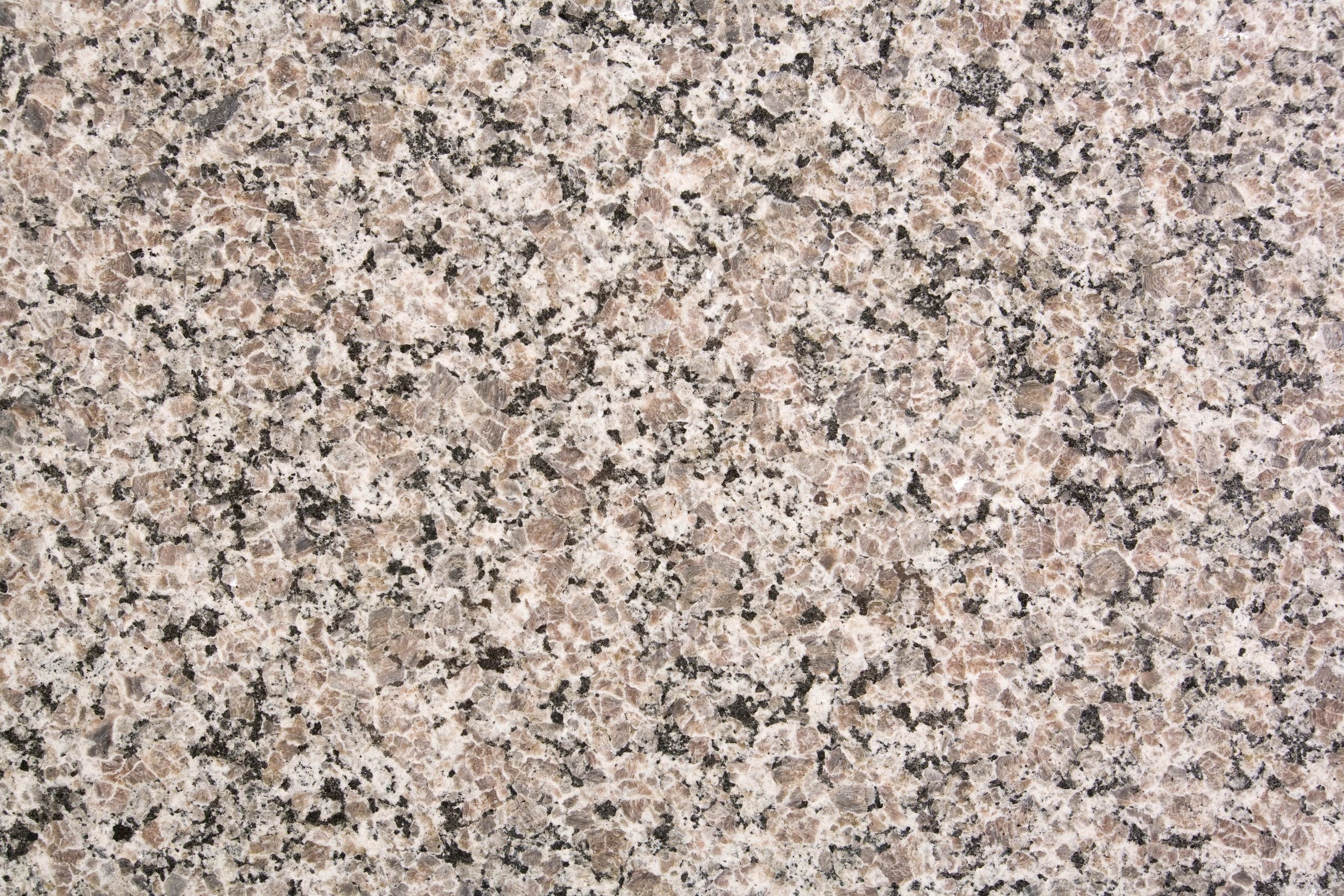 Neutral granite texture background with subtle grain variation.