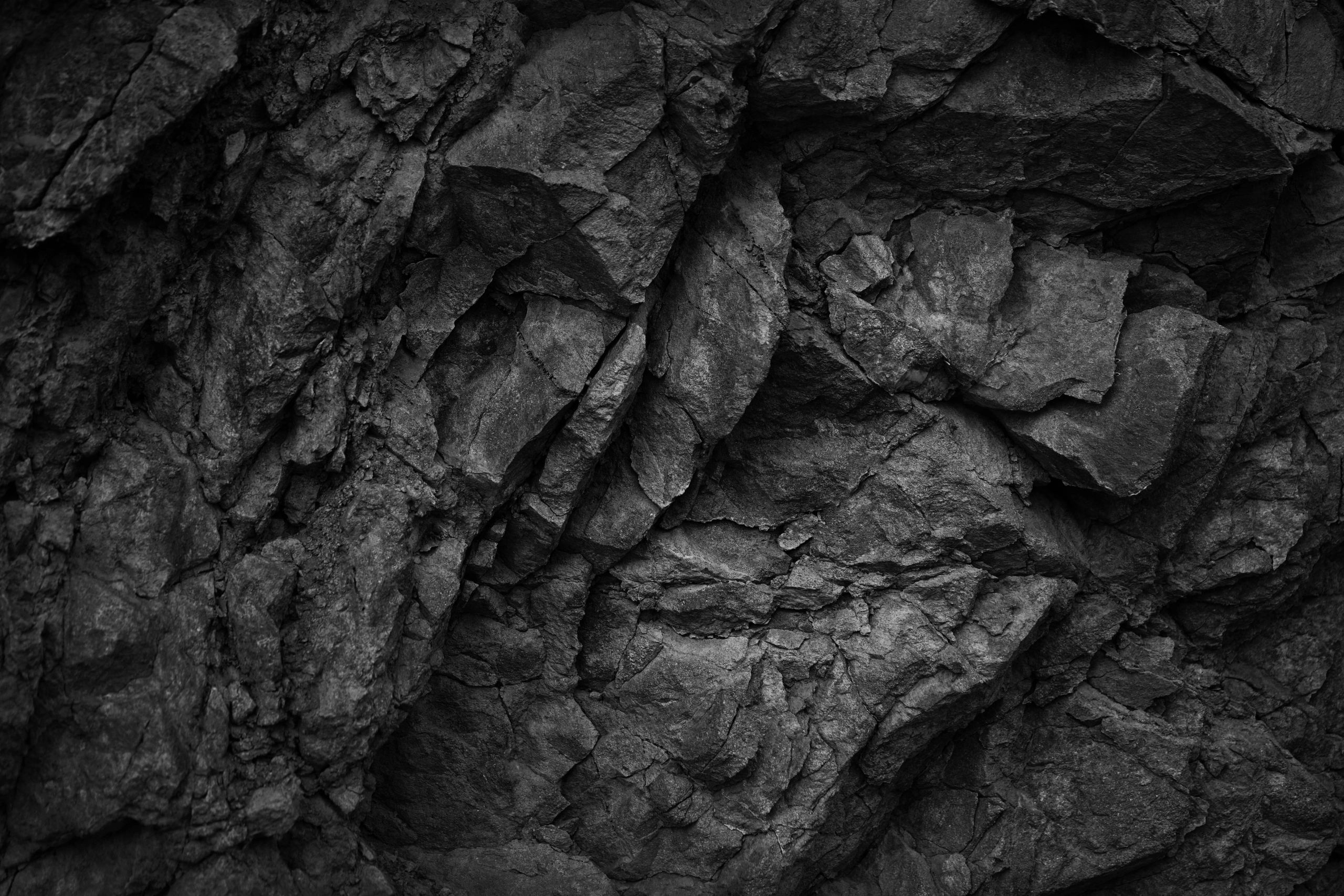 Dark basaltic rock texture with broken angular fragments