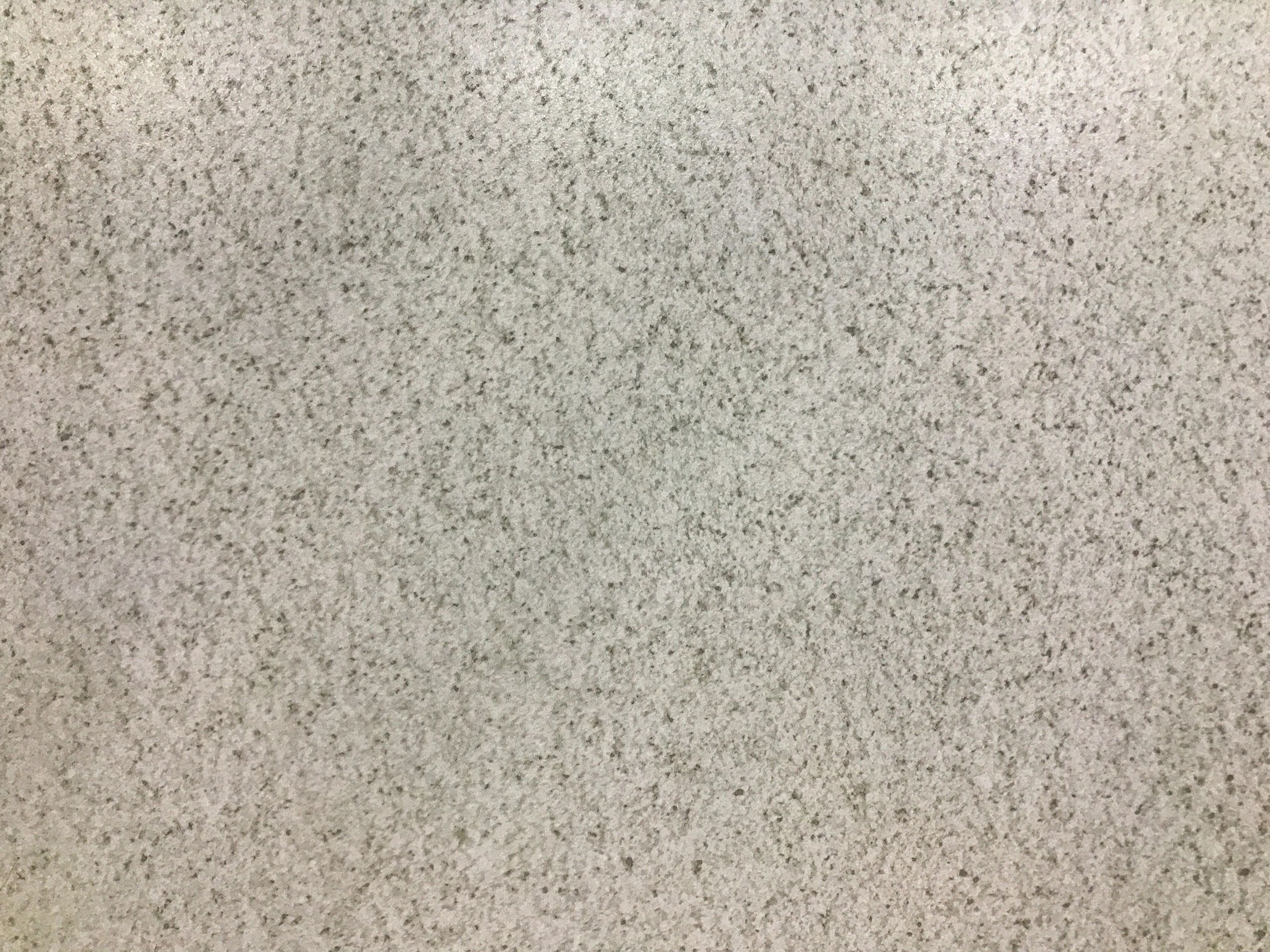 White and gray granite texture background with fine speckled pattern.