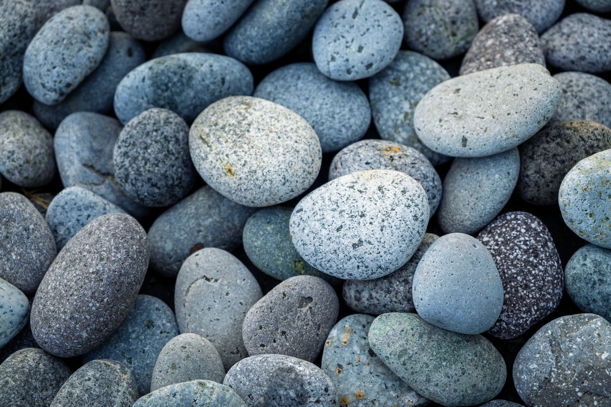 Smooth rounded pebbles texture close up
