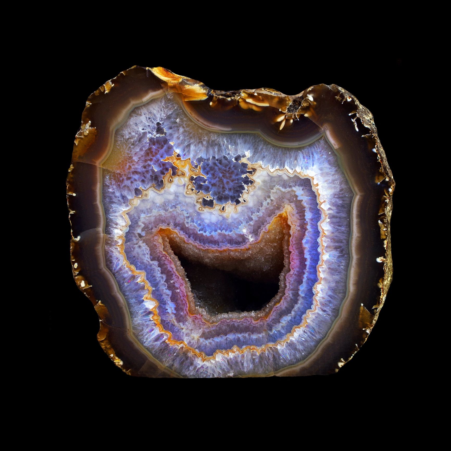 agate stone in cut isolated on black.