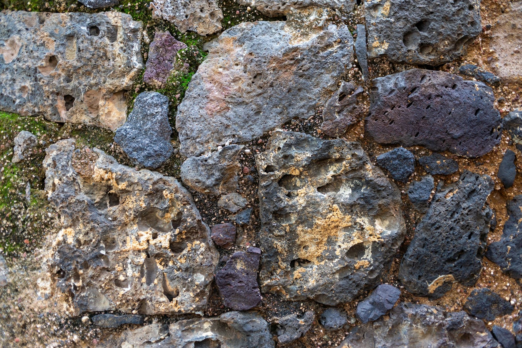 Volcanic rock surface with moss and natural pits