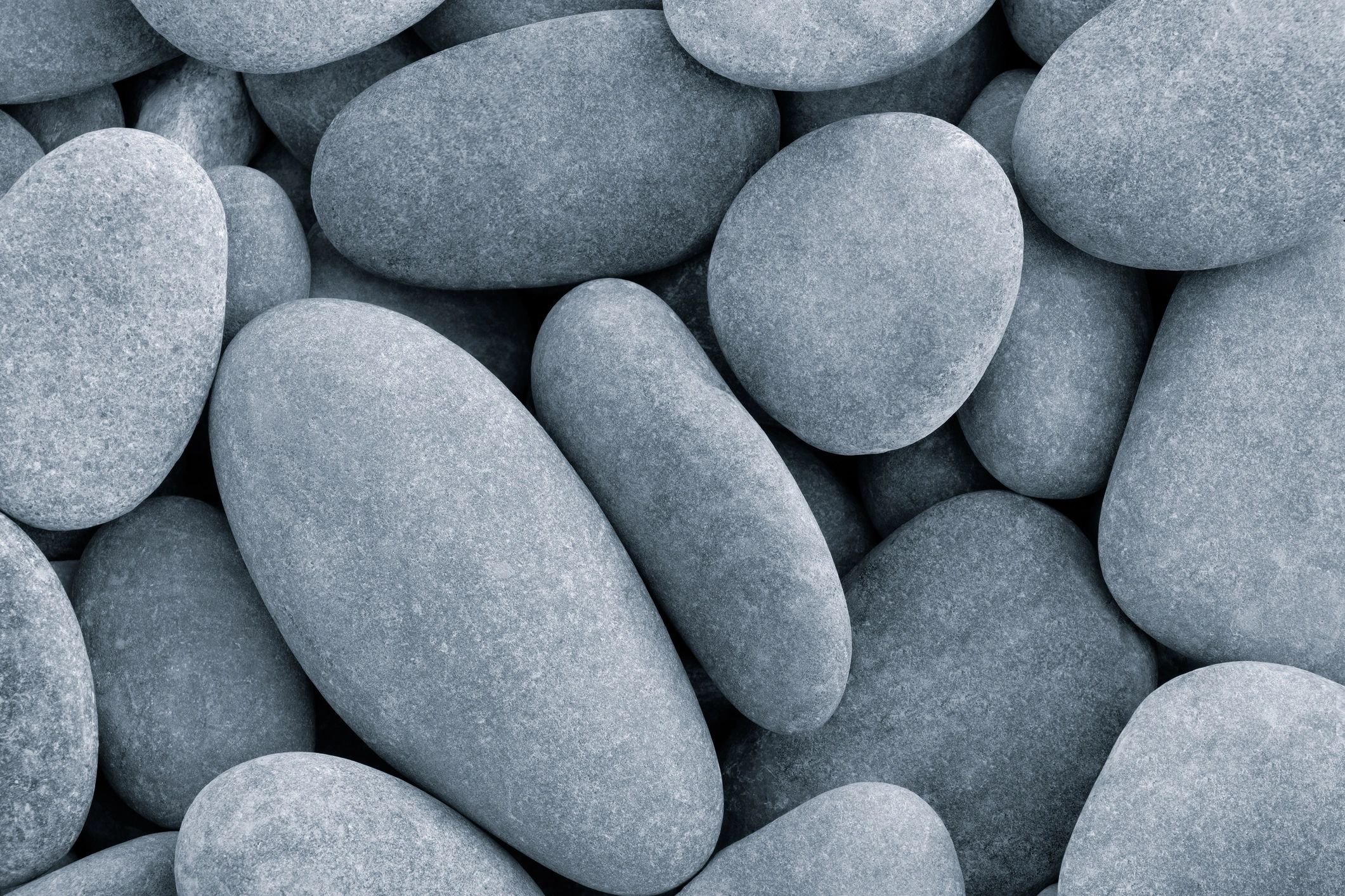 Sunlit beach pebbles forming a natural stone texture