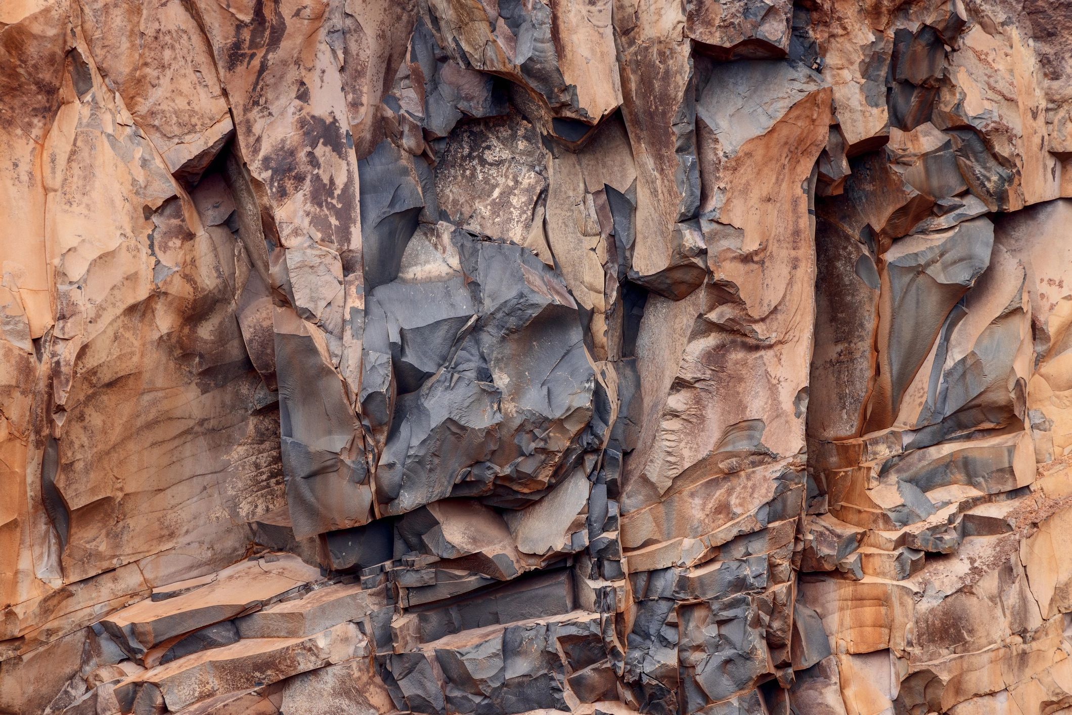 Volcanic rock texture background with layered basalt fractures