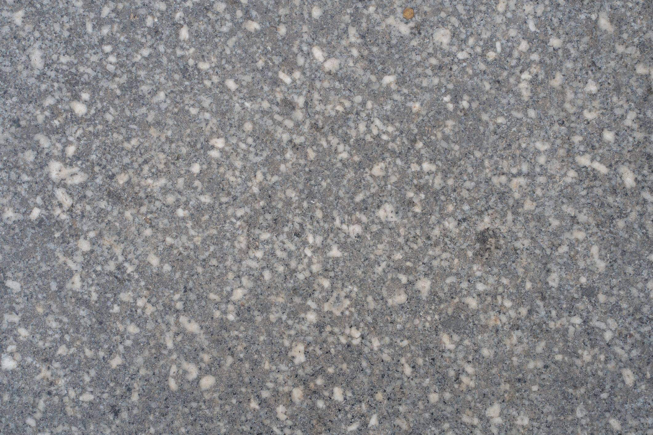 Gray speckled granite stone texture background.