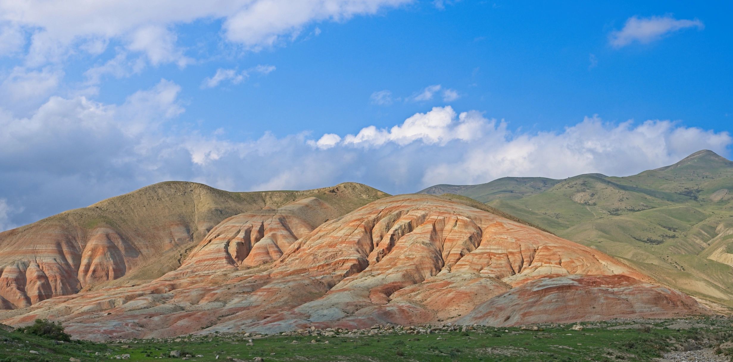 Striped sedimentary hills showing layered deposition