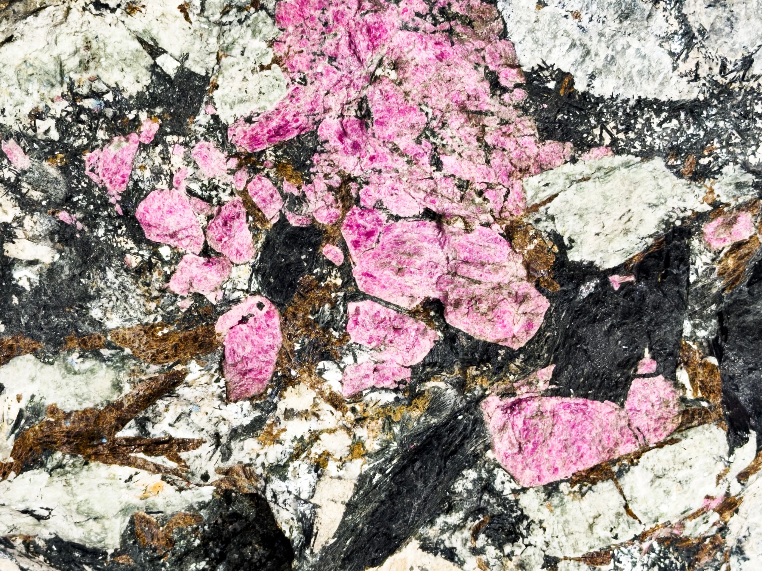 Pegmatite surface with feldspar and quartz crystals