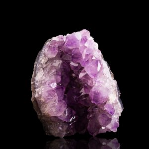 Polished amethyst cluster specimen on dark background